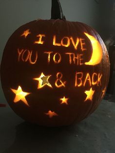 a carved pumpkin with the words i love you to the moon and back written on it