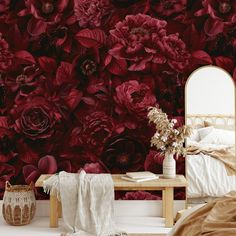 a bedroom with red flowers on the wall