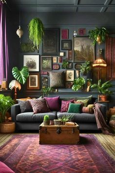 a living room filled with lots of plants and pictures on the wall behind a couch