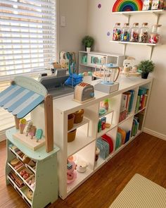 a child's playroom with shelves and toys