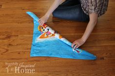 a person sitting on the floor with a shark shaped towel in front of them,