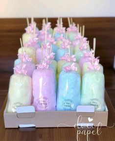 a box filled with different colored candles on top of a table