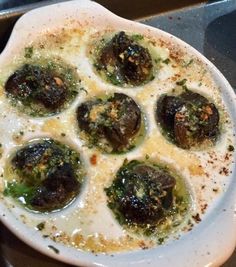 a white plate topped with meatballs covered in sauce