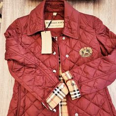 Burberry Crest Logo Jacket Luxury Burgundy Outerwear For Winter, Luxury Burgundy Winter Outerwear, Luxury Burgundy Outerwear For Fall, Luxury Long Sleeve Quilted Jacket For Fall, Luxury Red Fall Outerwear, Designer Red Long Sleeve Outerwear, Luxury Long Sleeve Quilted Jacket For Winter, Burberry Jacket Women, Burberry Quilted Jacket