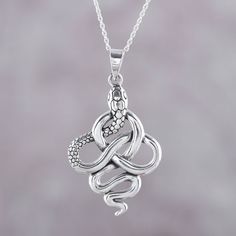 A sterling silver snake twists and turns neatly in and around itself to create a curving knot in this handcrafted pendant necklace. Designed by Neetu Barathi of India, the snake pendant hangs from a sterling silver cable chain that has an extender for ease in adjusting the length. Sterling Silver Snake Necklace For Gifting, Sterling Silver Snake Necklace For Gift, Gift Sterling Silver Snake Necklace, Snake-shaped Engraved Jewelry Gift, Silver Snake Chain Jewelry With Oxidized Finish, Silver Oxidized Snake Chain Jewelry, Silver Oxidized Finish Snake Chain Jewelry, Engraved Snake-shaped Jewelry Gift, Elegant Sterling Silver Snake Necklace