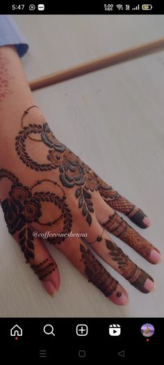 the hand is decorated with henna on it