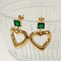 Product Name - Handmade Stainless Steel Gold Plated Irregular Heart Zircon Dangling Earrings With Green Emerald Stone Material - Stainless Steel, Gold Plated Uses & Purpose - Fashion Earring, Gift Size - 5MM Care Instruction - Handle With Care Heart-shaped May Birthstone Earrings For Anniversary, Heart Shaped May Birthstone Earrings For Anniversary, Gold Heart Shaped Crystal Earrings For Party, Elegant Green Heart Earrings For Gift, Heart Charm Earrings For Jewelry Making, Gold Heart-shaped Crystal Earrings For Pierced Ears, Green Heart Earrings For Valentine's Day Party, Gold Heart-shaped Crystal Earrings, Heart-shaped Green Jewelry With Matching Earrings