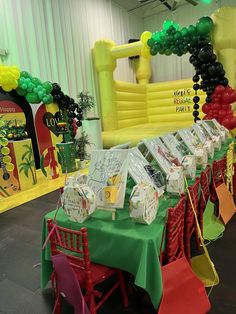 tables and chairs are set up in front of an inflatable arch with balloons