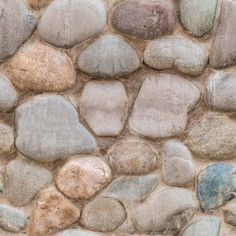 a stone wall with various colored rocks on it