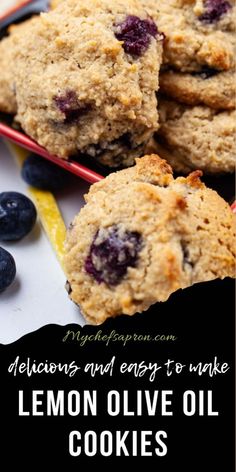 lemon olive oil cookies with blueberries on the side and text overlay that reads delicious and easy to make lemon olive oil cookies