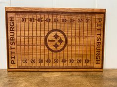 a wooden cutting board with the pittsburgh football team's name and date engraved on it