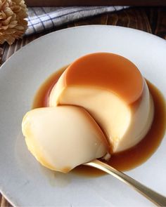 two scoops of caramel ice cream on a white plate