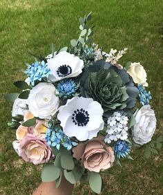 a person holding a bouquet of flowers in their hand