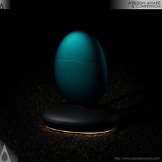 an illuminated egg sitting on top of a black surface in the dark with a caption above it