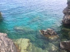 the water is crystal blue and green with rocks on either side that look like they are floating in the ocean