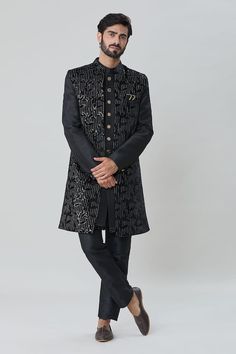 Black sleeveless jacket with all over leaf vine embroidery, sequin highlights. Paired with an inner sherwani and aligadhi pant. - Aza Fashions Fitted Festive Outerwear For Transitional Season, Fitted Transitional Outerwear For Festive Occasions, Festive Fitted Nehru Jacket With Embroidered Sleeves, Designer Black Festive Outerwear, Fitted Festive Outerwear With Embroidered Sleeves, Fitted Brocade Outerwear For Festive Season, Fitted Bandhgala With Zari Work For Fall, Festive Fitted Brocade Outerwear, Fall Bandhgala With Intricate Embroidery