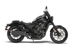 a black motorcycle is shown on a white background