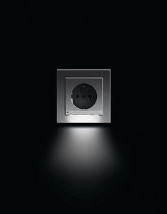 a black and white photo of a square light in the middle of a dark room