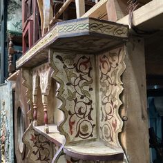 an intricately decorated shelf in the middle of a building