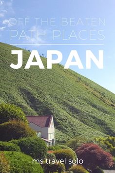 a house on top of a green hill with the words, off the beaten path places japan