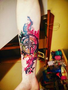 a person with a compass tattoo on their leg