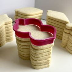 a stack of heart shaped cookies sitting on top of a table next to each other