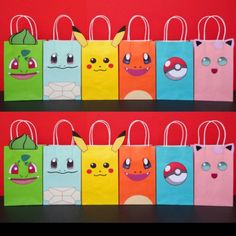 several bags with cartoon characters on them are lined up against a red wall in front of each other