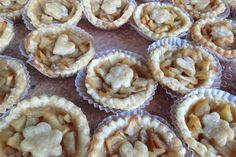 there are many small pies in the tray together on the table and ready to be eaten