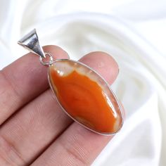 Item Description:-   Gemstone Pendant Name:- Natural Montana Agate Shape: Fancy Shape   Pendant Size:- 1.50 Inch US (Approx) Material:- 925 Silver Plated/ Gemstone Style:- Pendant Country/Region of Manufacture : India Made In : Jaipur Rajasthan  Please note that there will be slight changes in all stones in shade and texture in the actual product that you receive as these are made from natural gemstones. Stone quality or grade will be same. Kindly contact us if you need these in wholesale quanti Orange Agate Cabochon Jewelry, Orange Oval Agate Jewelry, Oval Orange Agate Jewelry, Orange Agate Pendant Jewelry, Loop Necklace, Montana Agate, Boho Pendant, Jewelry Crystal, Bezel Pendant