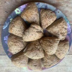 a plate full of heart shaped biscuits on a wooden table with purple and blue flowers