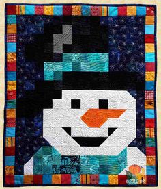 a quilted snowman with a hat and scarf on it's head is shown