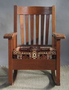 a wooden chair sitting on top of a rug