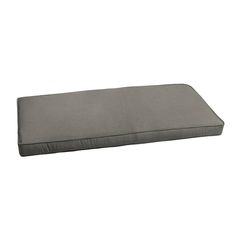 a gray pillow sitting on top of a white floor