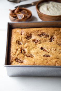 a loaf of bread sitting on top of a pan next to other food and utensils