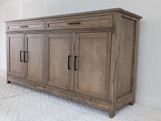 a large wooden cabinet sitting on top of a white floor