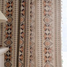 the curtains in this room are made from different colors and patterns, but not very plain