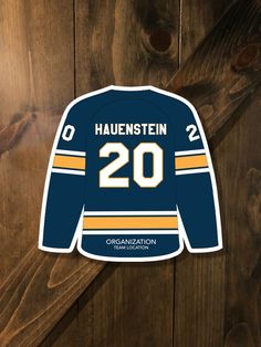 a hockey jersey with the number 20 on it is hanging from a wooden wall in front of wood planks