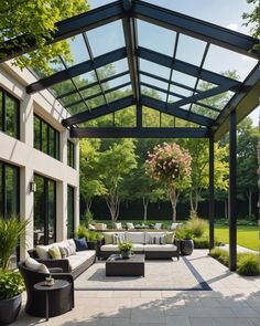 an outdoor living area with couches, tables and chairs in the middle of it