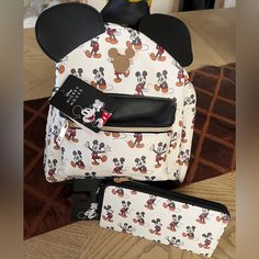 Disney’s Mickey Mouse Classic Toss Pattern Backpack Show Off Your Favorite Character With This Disney's Mickey Mouse Classic Toss Pattern Backpack. Product Features 10"H X 10.5"W X 5"D Handle: 2.5'' Drop Shoulder Strap Length: 16" - 34" Zipper Closure Inferior: 1 Zip Pocket Exterior: 1 Zip Pocket And 2 Slip Pockets Construction & Care Exterior: Saffiano Pu Lining: 100% Recycled Polyester Includes Wallet! Brand New W/ Tags! Disney Mickey Mouse Bag For Back To School, White Mickey Mouse School Backpack, White Mickey Mouse Backpack For Travel, White Mickey Mouse Travel Backpack, Mickey Mouse Backpack For Daily Use, White Mickey Mouse Bag For Disney Fan Events, White Minnie Mouse School Bag, Disney Bags For Daily Use And Back To School, Mickey Mouse Everyday Backpack