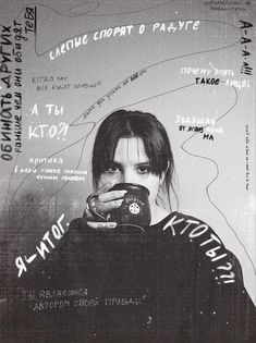 a black and white photo of a woman holding a camera with graffiti all over her face