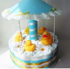 a cake decorated with rubber ducks and an umbrella