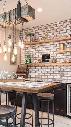 an industrial style kitchen with brick wall and bar stools