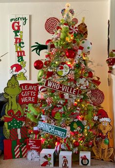 a christmas tree decorated with candy canes and grin the cat signs is surrounded by other holiday decorations