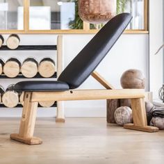 a wooden bench sitting in front of a wine rack