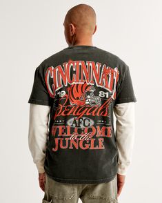 Showcase your team spirit with the Abercrombie & Fitch Men's Cincinnati Bengals Graphic Tee. This black textured shirt is designed for the ultimate fan, featuring bold graphics on both the chest and back that celebrate your favorite NFL team.

- Size: XL
- Color: Black Texture
- Material: Cotton
- Gender: Male
- Age Group: Adult
- Features: Short sleeves, crew neckline, relaxed-fit silhouette

Crafted from A&F's signature softAF fabric, this tee offers both supreme comfort and durable wear, maki Texture Material, Textured Shirt, Black Texture, Neckline Designs, Men's Tops, Tennessee Titans, Silhouette Crafts, Bold Graphics, Black Textures