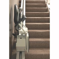 a stair lift is attached to the side of a set of stairs with an electronic device on it