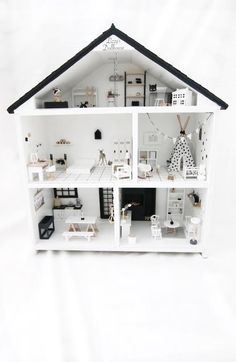 a doll house with all the furniture and accessories in it's white display case