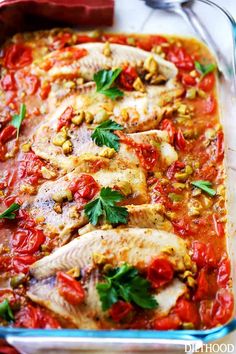 baked fish with tomato sauce and herbs in a casserole dish