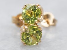 "Be the envy of all your friends with these gorgeous yellow gold and peridot stud earrings! With their sparkly peridot stones and luxurious yellow gold setting, you'll be sure to dazzle wherever you go. Get ready to shine! Metal: 14K Yellow Gold Gem: 2 Peridot totaling 1.05 Carats Gem Measurements: 5.0 mm, Round Marks: \"14K\" Stamped on the findings SKU #: A30150 Each piece has been identified and graded by a Graduate Gemologist who has been certified by the Gemological Institute of America (GIA). We have six brick-and-mortar storefronts in Maine, Massachusetts, and New Hampshire and have been in business for over 25 years! Please visit our Shop's About Page or our website for more information about our jewelry. For questions about diamond grading, we recommend the  Gemological Institute Peridot Earrings, Stud Earrings Gold, Peridot Stone, August Birthstone, Yellow Gold Setting, August Birth Stone, To Shine, Gold Earrings Studs, Pearl Pendant