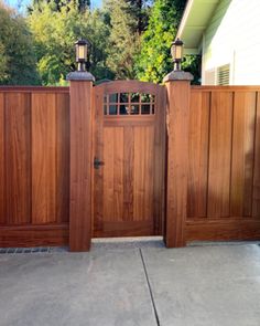 a wooden gate with two lights on each side